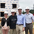 Photo of Nelson Mullins employees in front of a construction site