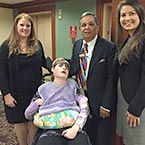 Three Nelson Mullins attorney and a wheelchair user