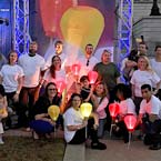 Group phot of Nelson Mullins employees holding a lighted lantern