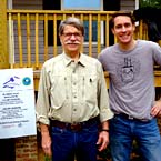 2 Nelson Mullins attorneys in front of a home