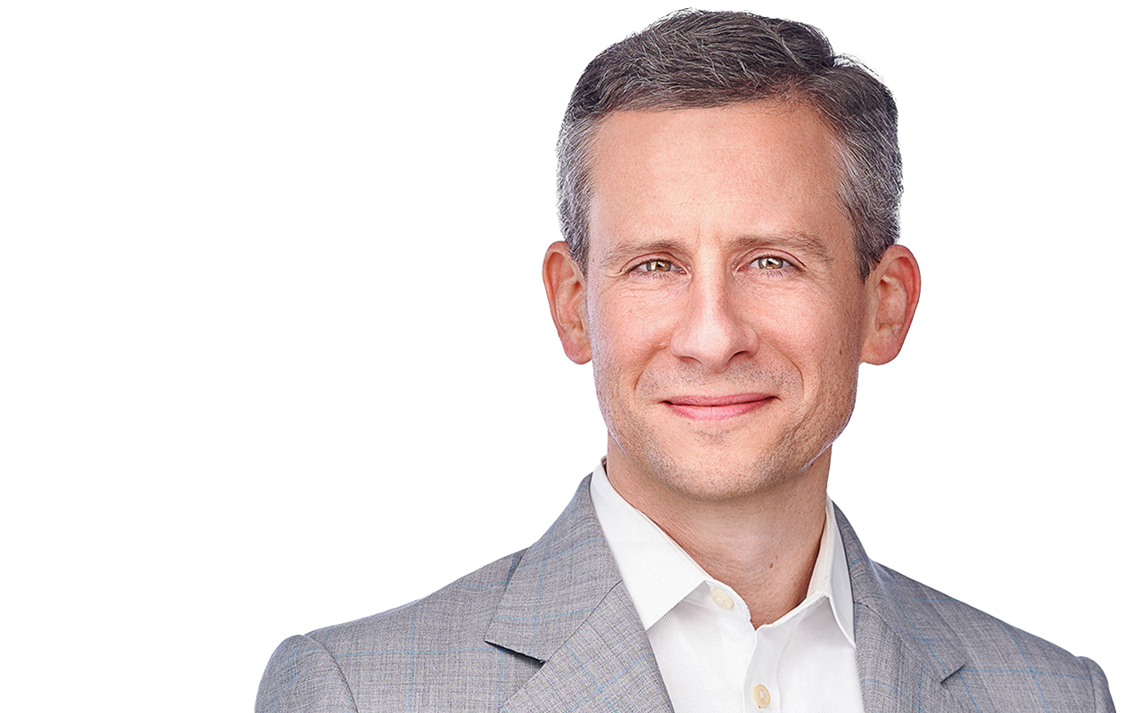 A portrait of partner Ben Hron against a white background is pictured.